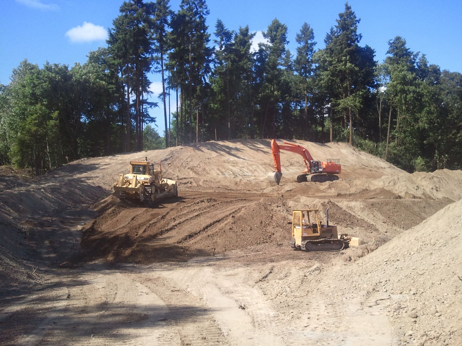 Excavator and dozer on a large mass-earthwork site
