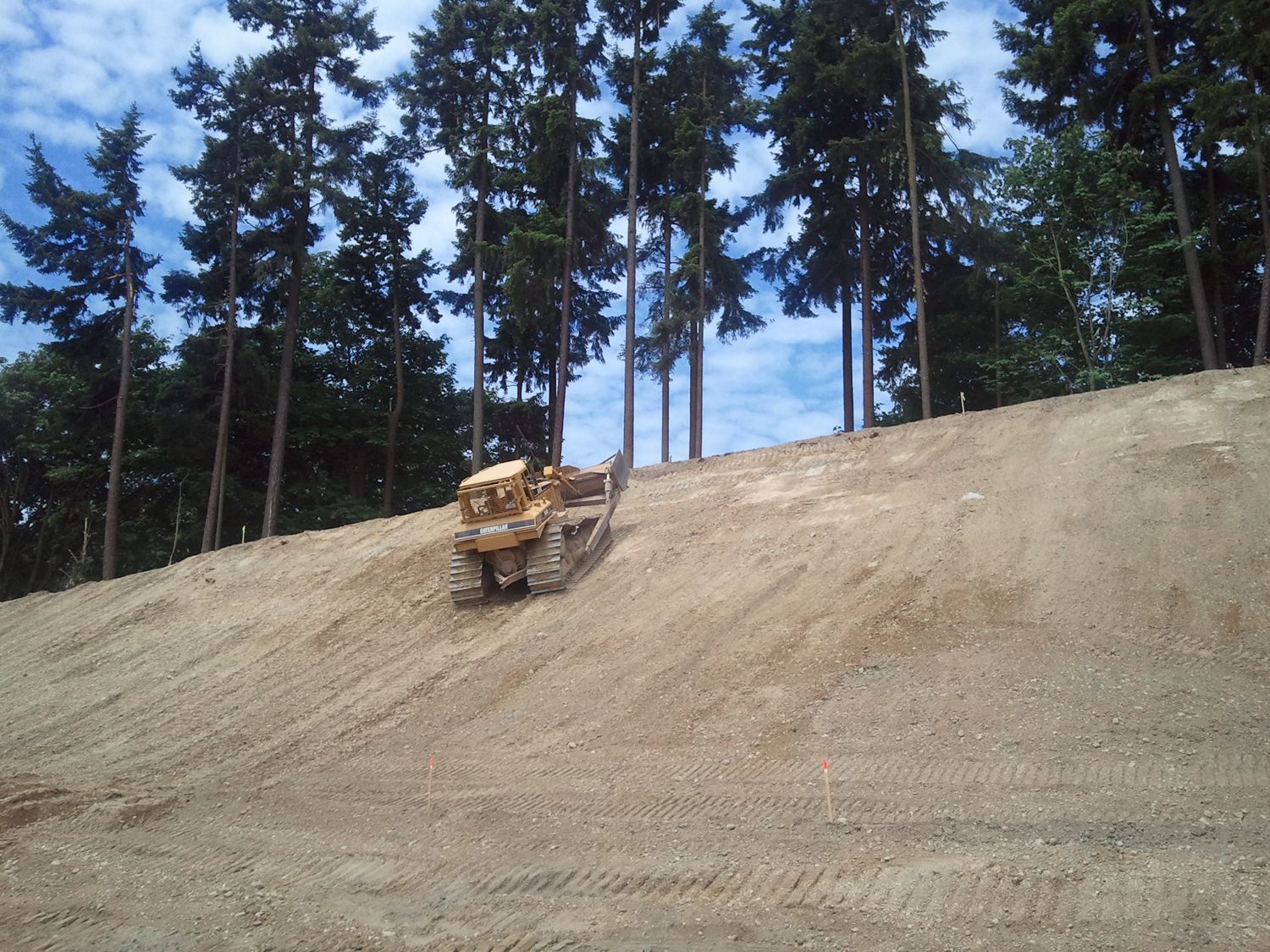 Dozer grading a large engineered slope